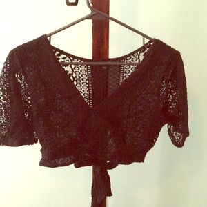 Black lace crop top with sleeves.